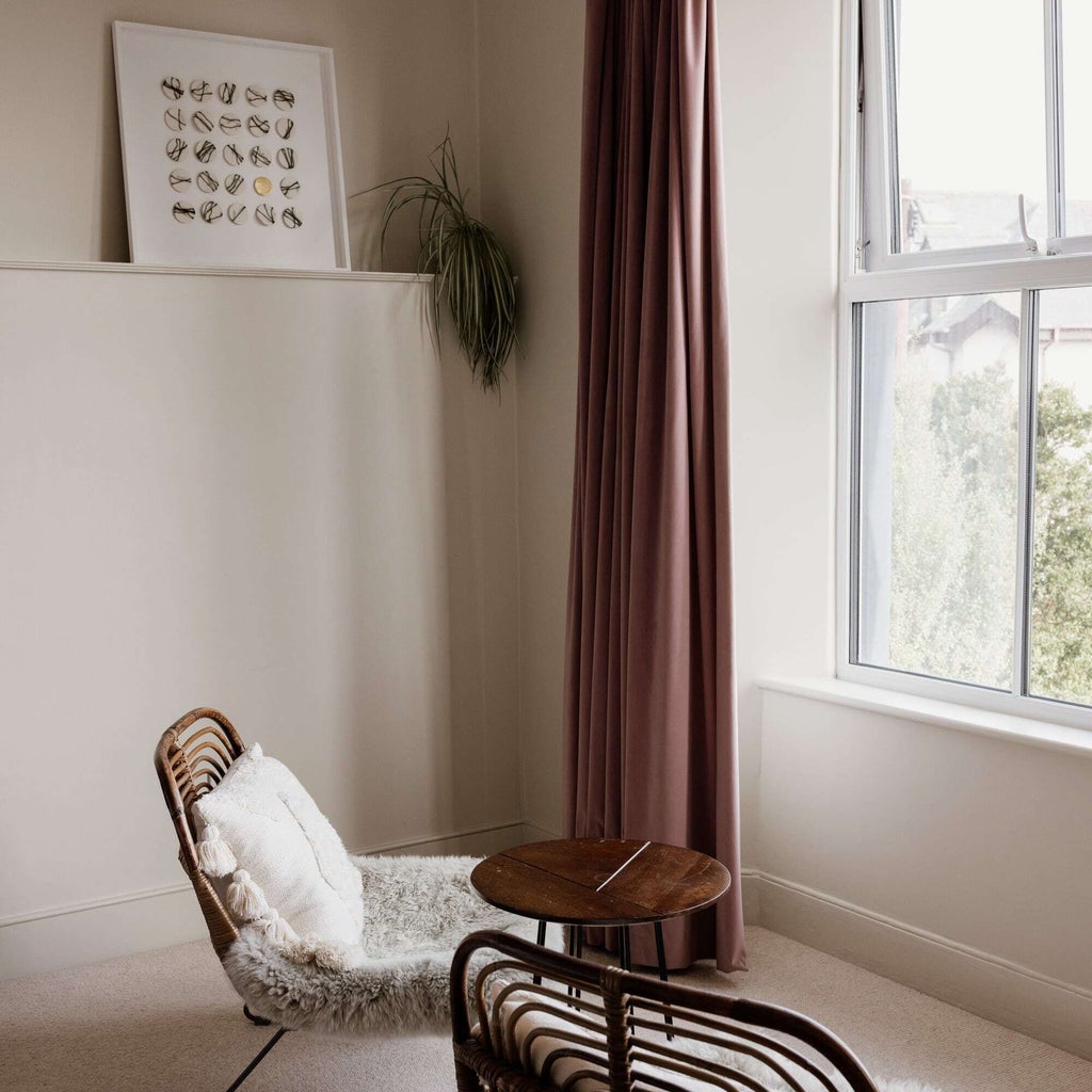 Luxurious bedroom with plush white bedding, soft neutral tones, elegant contemporary furnishings, and warm lighting in a boutique UK hotel room