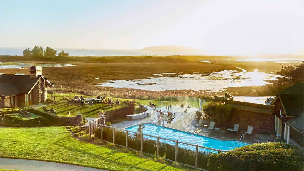 Luxurious coastal resort nestled in scenic Bodega Bay, featuring modern rustic architecture, expansive ocean views, and elegant wood-paneled exterior at sunset