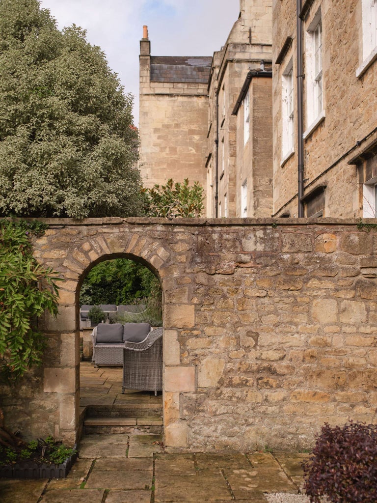 Elegant Georgian townhouse hotel with cream facade, large windows, and classic architectural details, showcasing luxury accommodation in Bath's historic city center