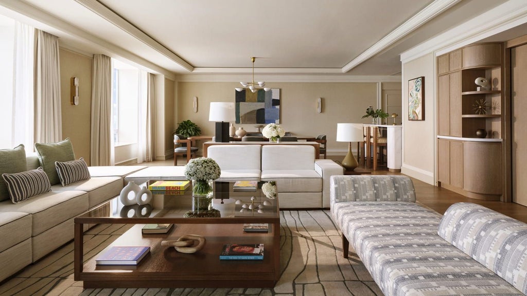 Luxurious penthouse suite at Four Seasons Hotel Miami with panoramic ocean views, contemporary design, plush king bed, and floor-to-ceiling windows overlooking cityscape