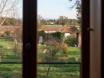 Elegant Michelin-starred restaurant nestled in French countryside, featuring sleek modern architecture with expansive windows overlooking lush green landscape