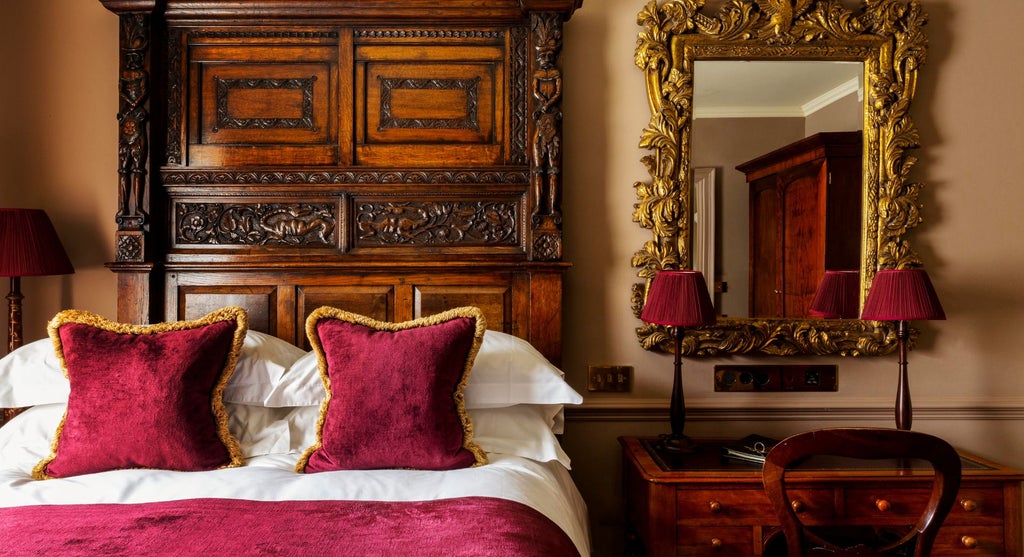 Elegant boutique hotel room with ornate four-poster bed, rich emerald green walls, vintage decor, and luxurious Georgian-inspired design at Batty Langley's