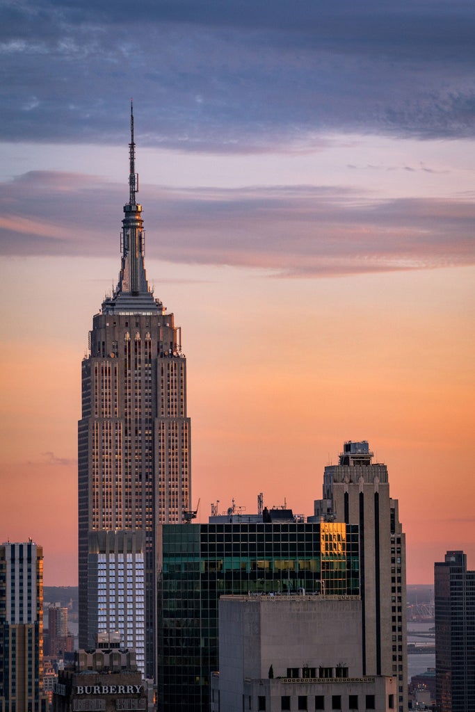 Luxurious Four Seasons hotel's art deco limestone tower rises above Manhattan, featuring elegant windows and ornate architectural details