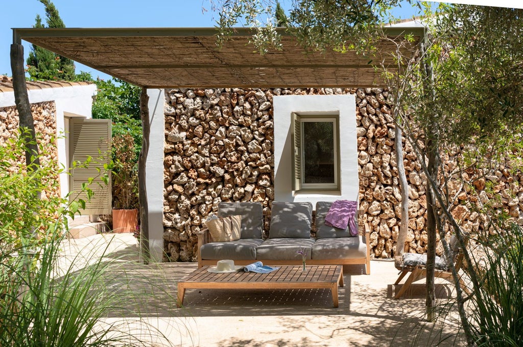 Rustic stone cottage with private garden at Torralbenc, Mediterranean landscape with lavender and stone walls, sun-drenched Menorca countryside retreat