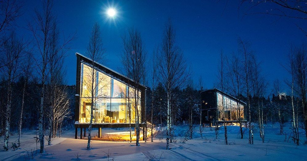 Minimalist wooden cabin suite with panoramic Arctic views, natural light, modern Scandinavian design, floating on frozen water near snow-covered landscape