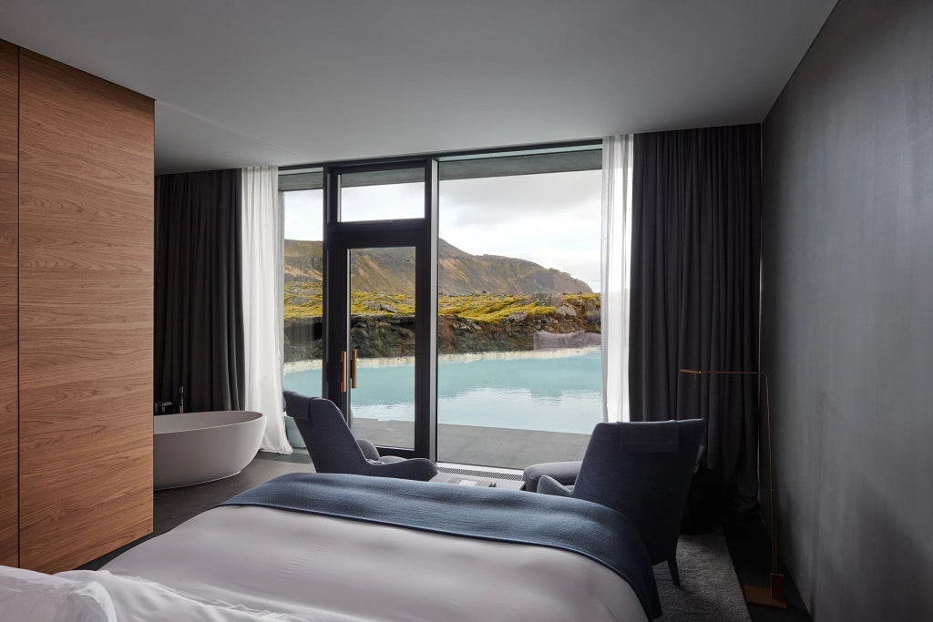 Luxurious eco-friendly hotel nestled in rugged Icelandic landscape, featuring minimalist Nordic architecture and sweeping panoramic views of volcanic terrain