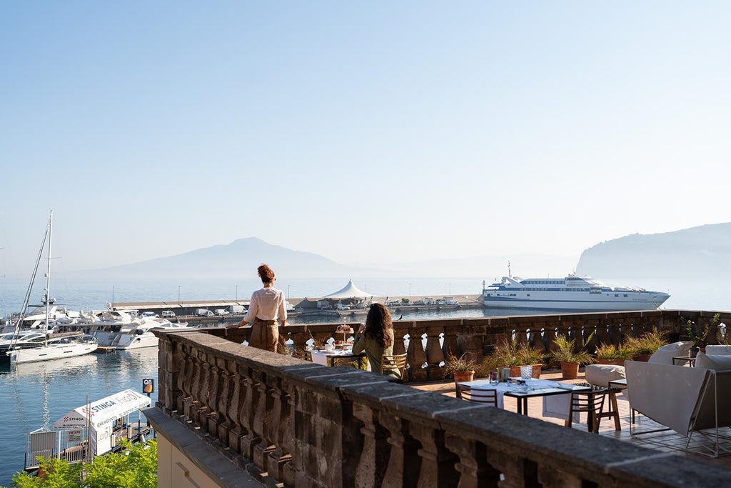 Elegant white Mediterranean hotel with arched windows, private terraces and panoramic sea views along the iconic Amalfi Coast