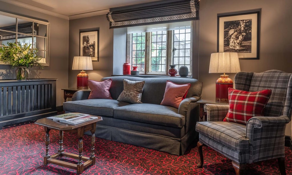 Luxurious cottage duplex suite at The Lygon Arms, featuring elegant furnishings, plush bedding, and traditional British countryside charm with modern amenities.