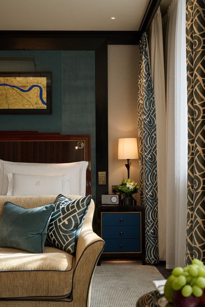 Elegant classic room with soft neutral tones, plush white bedding, and refined decor at a luxurious hotel in Mayfair, London's prestigious district