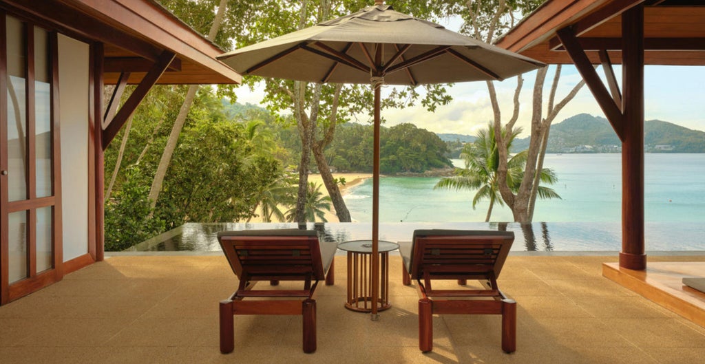 Elegant Thai pavilion room with private infinity pool overlooking Andaman Sea, featuring teak furnishings and tropical landscaping