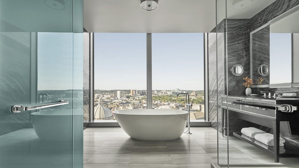 Luxurious glass-and-steel exterior of Four Seasons Hotel at Scenset Dalton Street, gleaming modern architecture with reflective windows against Boston's urban skyline