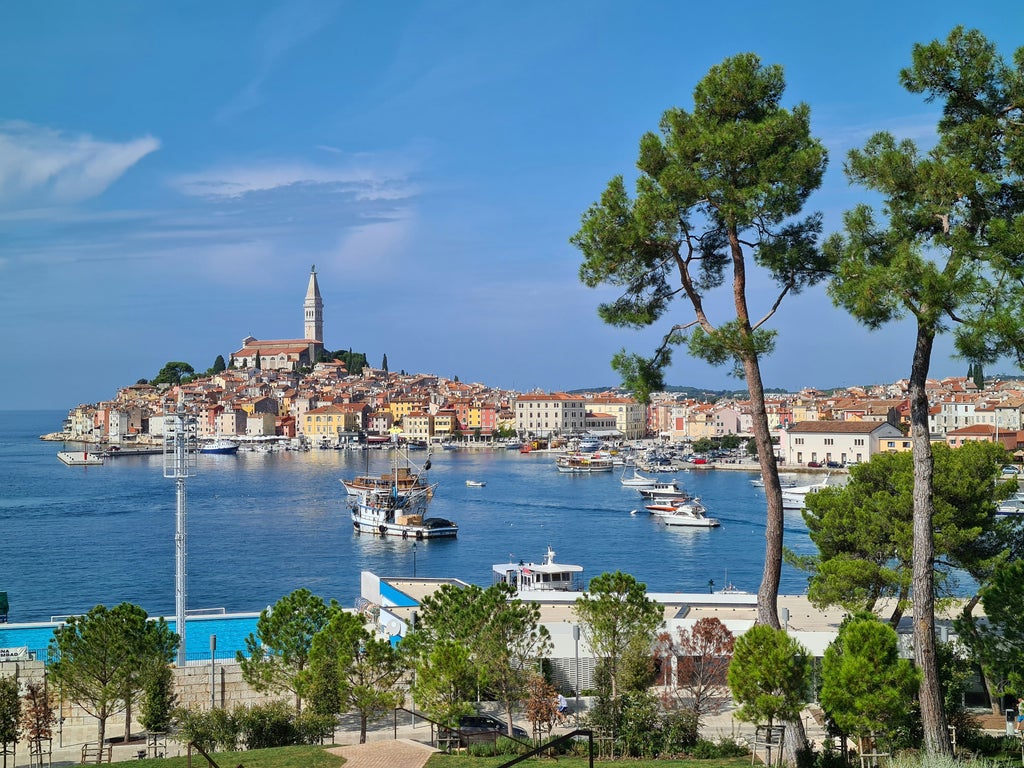 Sweeping coastal view of Croatia's Istria peninsula with terracotta-roofed medieval towns perched on hilltops above the azure Adriatic Sea