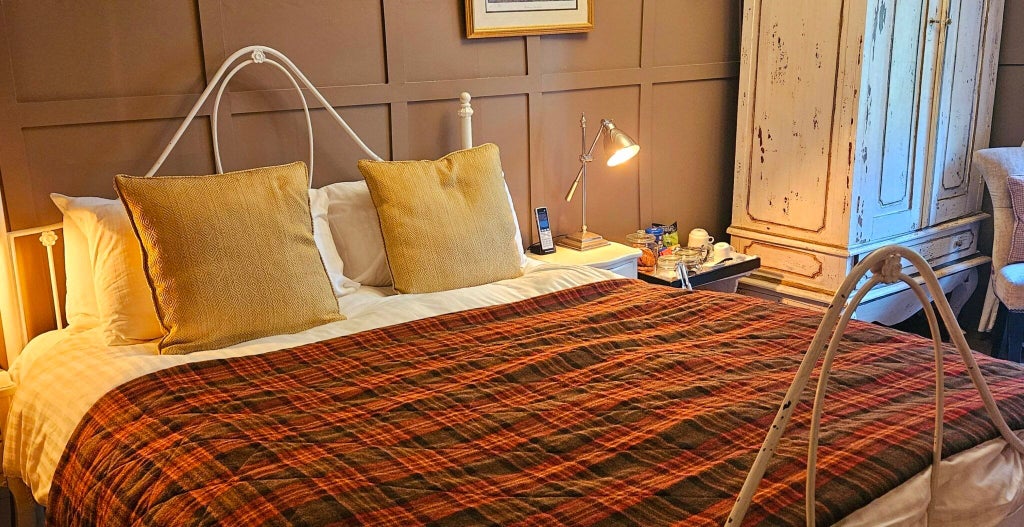 Elegant seaside hotel room with plush bedding, coastal-inspired decor, and panoramic views of the Scottish landscape at Scenset Manor Hotel