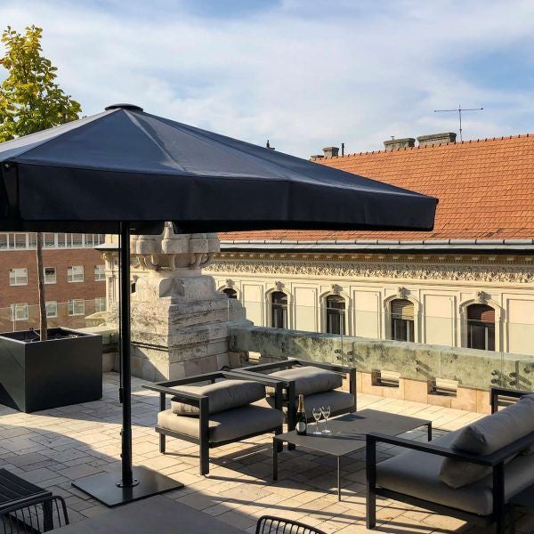 Luxurious rooftop terrace of modern hotel with panoramic city views, elegant outdoor seating, and sleek architectural design overlooking urban landscape at sunset