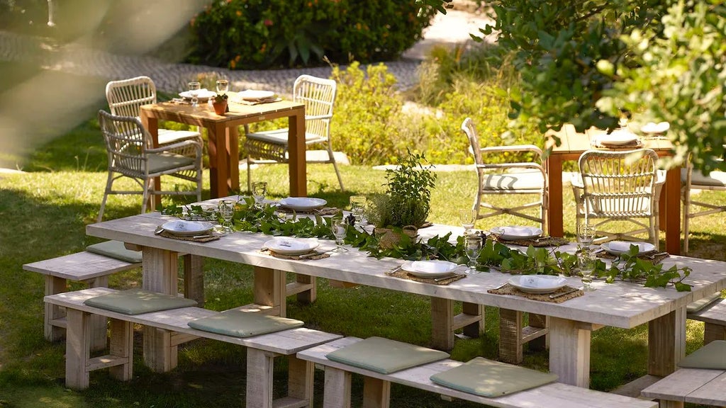 Luxurious whitewashed Portuguese farmhouse-style hotel with rustic terracotta roofs, surrounded by lush gardens and minimalist Mediterranean landscape