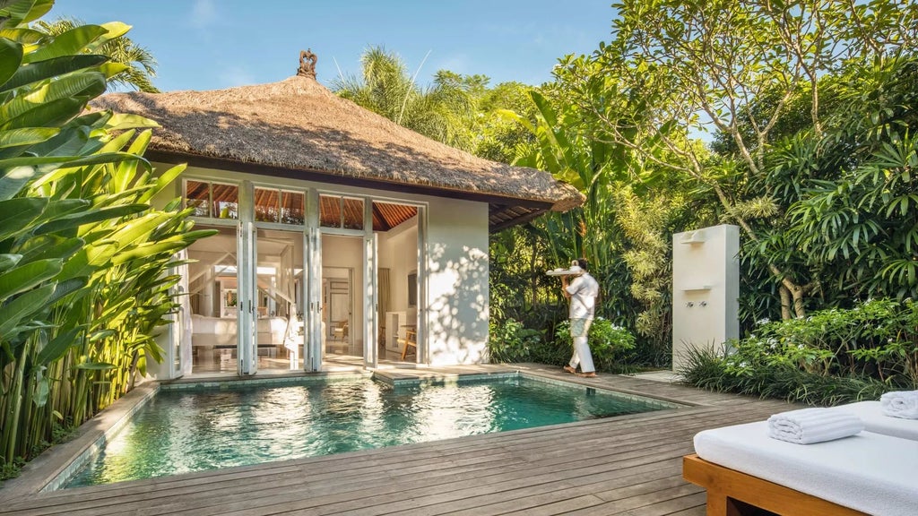 Luxurious COMO Uma Ubud resort nestled in lush Balinese jungle, featuring elegant infinity pool with dramatic tropical landscape backdrop