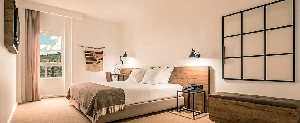 Elegant double room with panoramic valley views, featuring modern decor, plush bedding, and large windows showcasing scenic Portuguese landscape at Lamego Hotel & Life