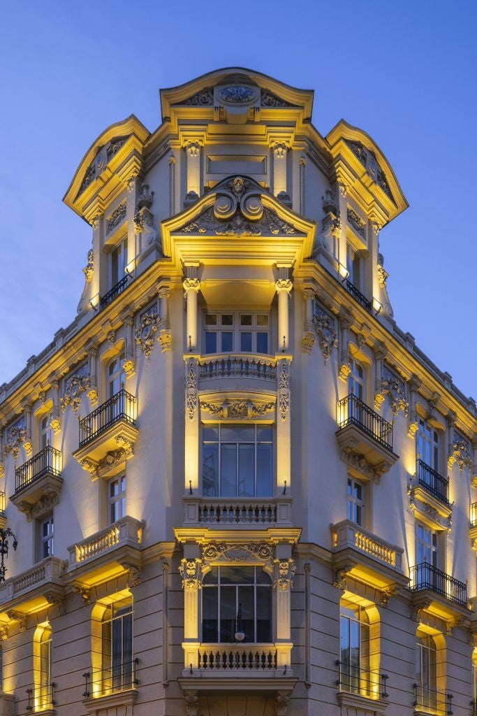 Elegant white and beige luxury hotel lobby with plush seating, marble floors, and refined architectural details in scenset, Spain.