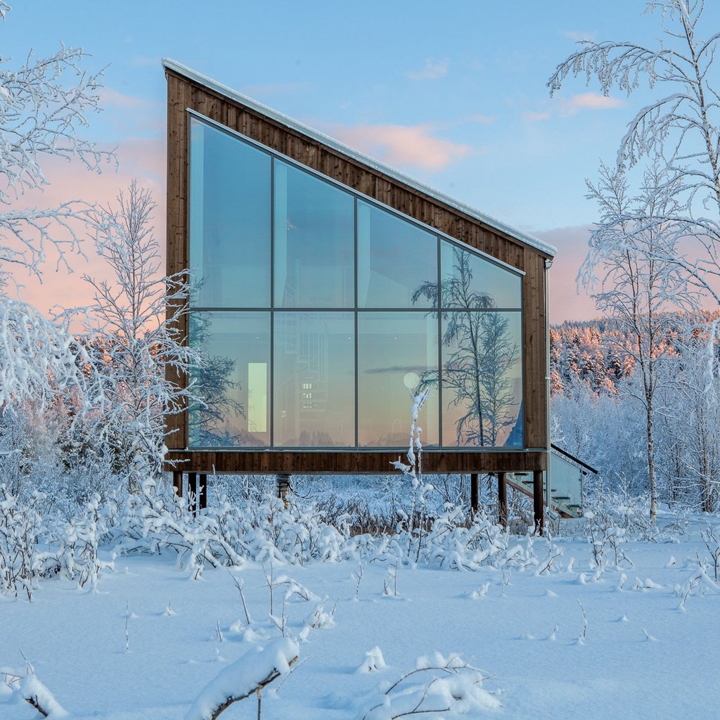 Luxurious circular wooden spa hotel suspended over frozen river in Harads, Sweden with snow-covered pine trees and minimalist Nordic architecture