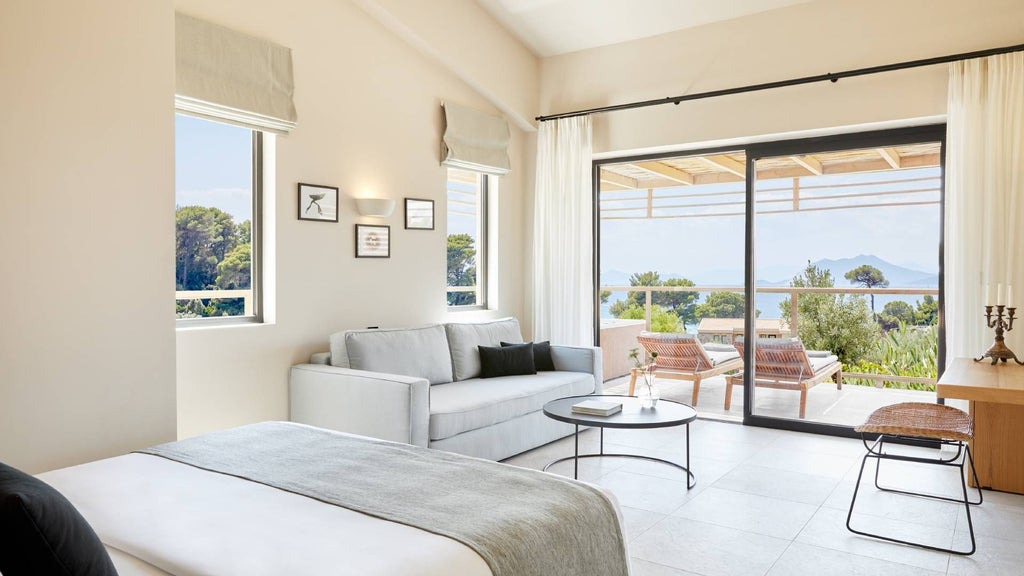 Luxurious interconnected suite with private hot tub overlooking azure Aegean Sea, featuring modern minimalist design and seamless indoor-outdoor living in Skiathos, Greece