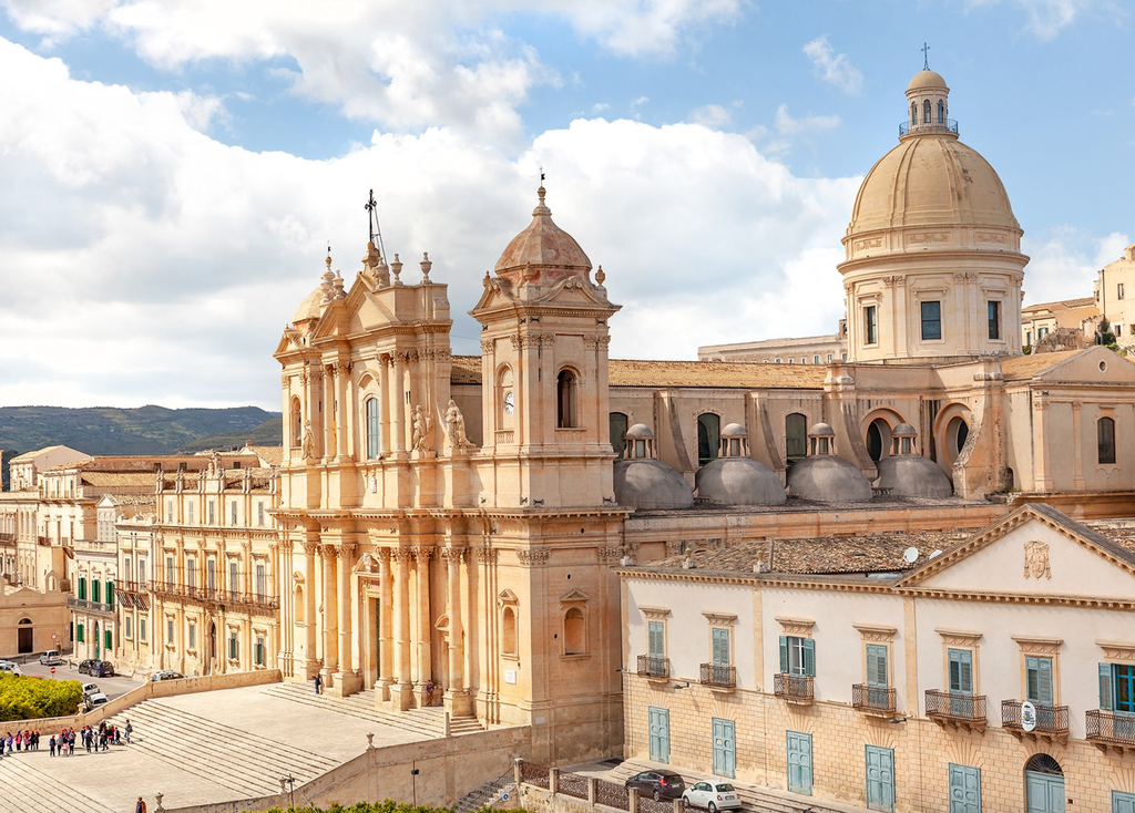 Elegant baroque architecture of Noto, Sicily, with sun-drenched limestone buildings and ornate balconies reflecting golden Mediterranean light