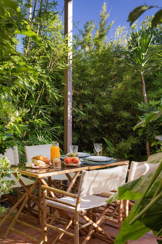 Luxurious rustic stone country house with terracotta roof nestled in lush Portuguese countryside, surrounded by verdant gardens and rolling hills