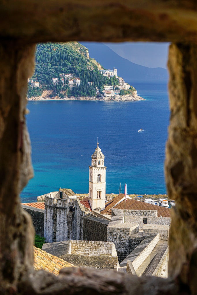 Group explores Dubrovnik's iconic limestone streets, surrounded by medieval walls and terracotta rooftops under bright Mediterranean sun