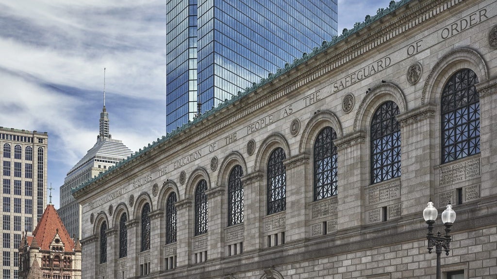 Luxurious glass-clad modern high-rise hotel tower in downtown Boston with sleek architecture, reflecting city skyline and urban sophistication