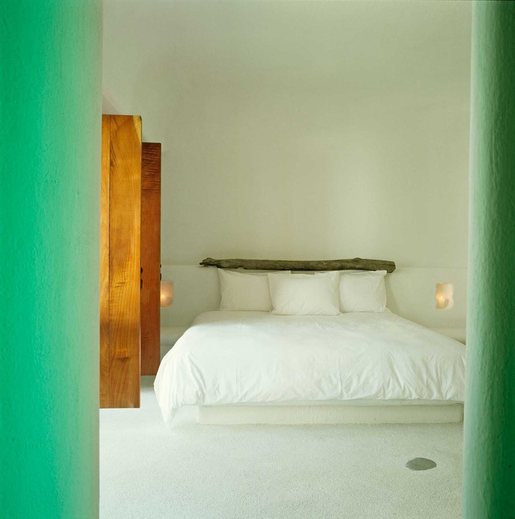 Elegant double bedroom in luxury boutique hotel, white linens, minimalist decor, warm wooden floors, soft natural light streaming through sheer curtains in Mexico