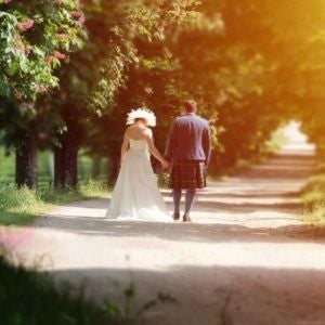 Elegant French château nestled in lush Dordogne countryside, featuring refined stone architecture, manicured gardens, and warm golden sunlight.