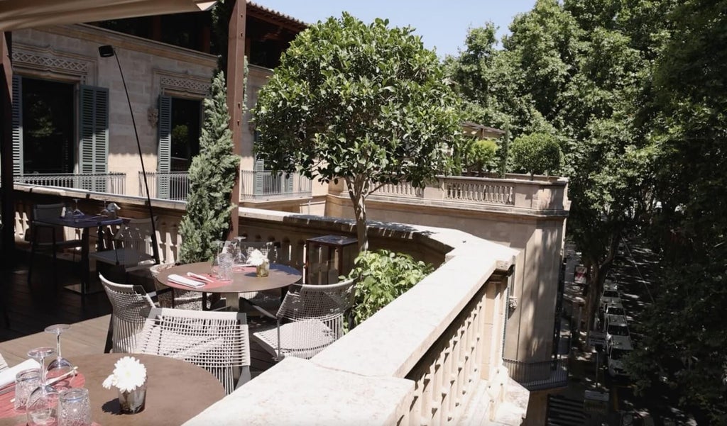 Elegant stone balconies and ornate archways adorn the historic facade of Can Alomar luxury hotel in Palma's prime shopping district