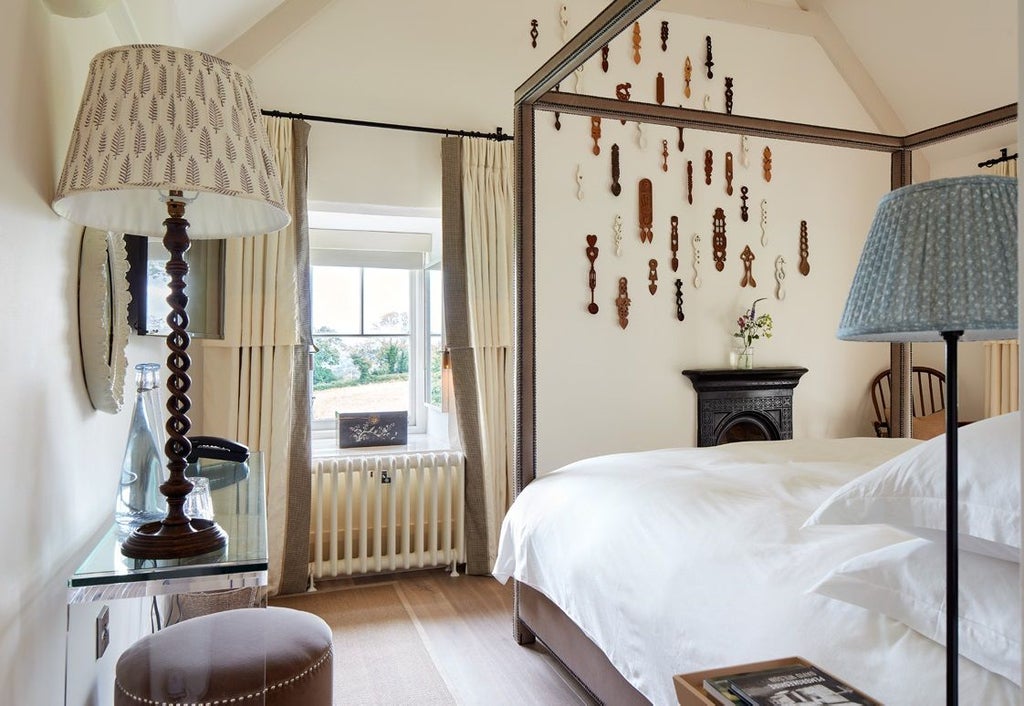 Luxurious countryside hotel room with soft neutral tones, elegant four-poster bed, and refined traditional Welsh decor at Grove of Narberth boutique property