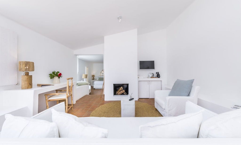 Luxurious whitewashed Portuguese hotel room with minimalist design, soft neutral tones, elegant wooden furniture, and natural light streaming through large windows.