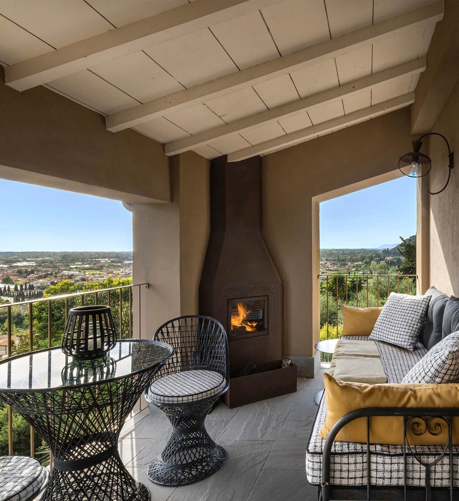 Rustic Tuscan boutique hotel with stone walls, elegant terracotta-tiled roof, and panoramic countryside views near scenic Italian landscape