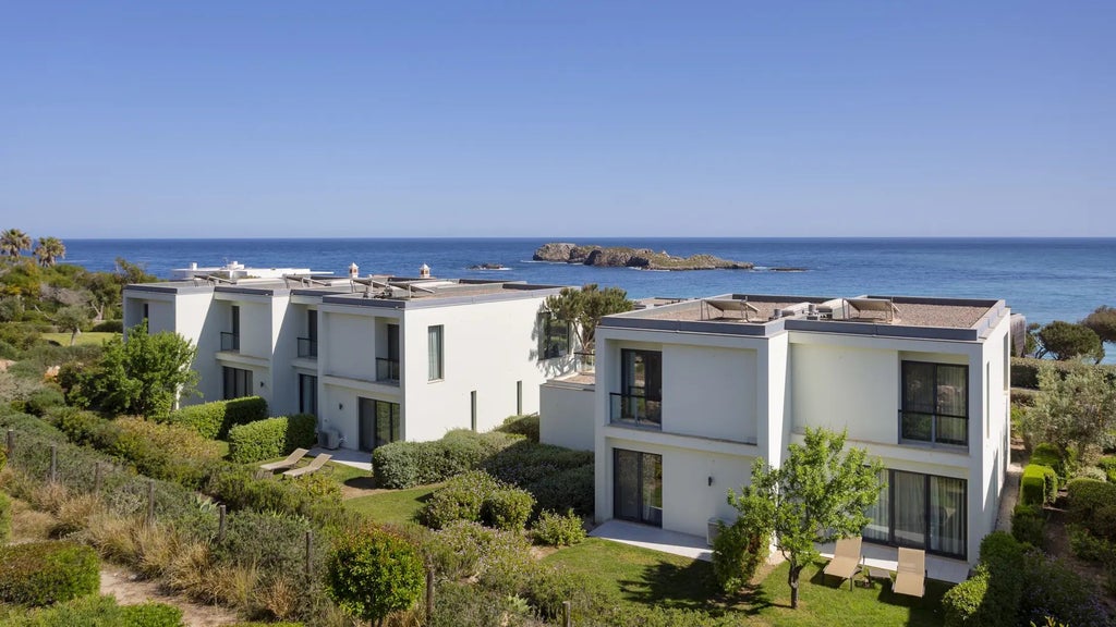 Luxurious oceanfront villa with modern architecture, spacious balcony, and panoramic views of Sagres coastline, blending contemporary design with natural landscape