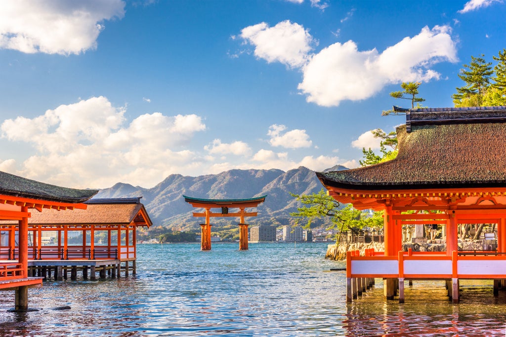 Peaceful Hiroshima memorial garden with cherry blossoms, stone monuments, and reflecting pools showcasing historical landscape and tranquil commemorative atmosphere