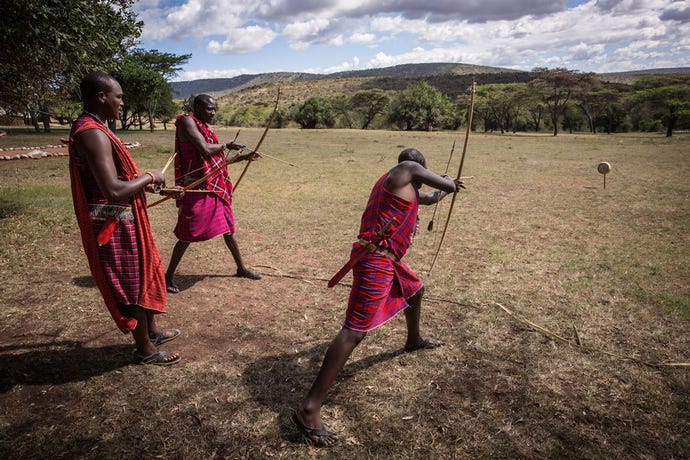 Maasai demonstrating their techniques with a bow and arrow