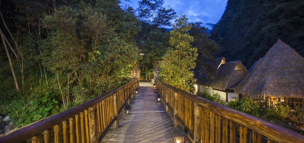 Luxurious stone and adobe cottages nestled in lush Andean cloud forest, with traditional Peruvian architecture and flowering gardens