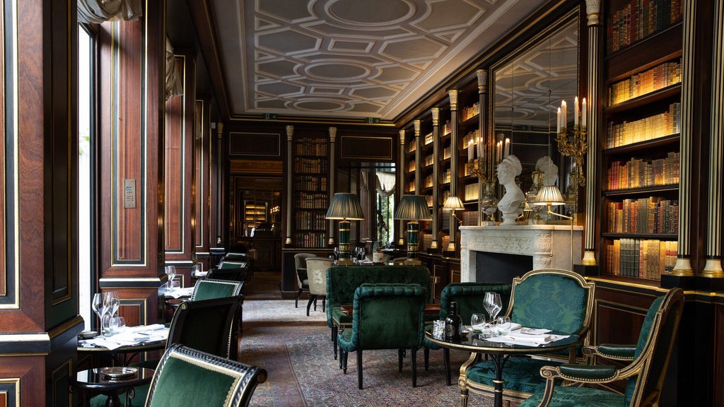 Elegant Parisian luxury hotel exterior with neoclassical architecture, grand windows, and manicured landscaping under soft evening light.