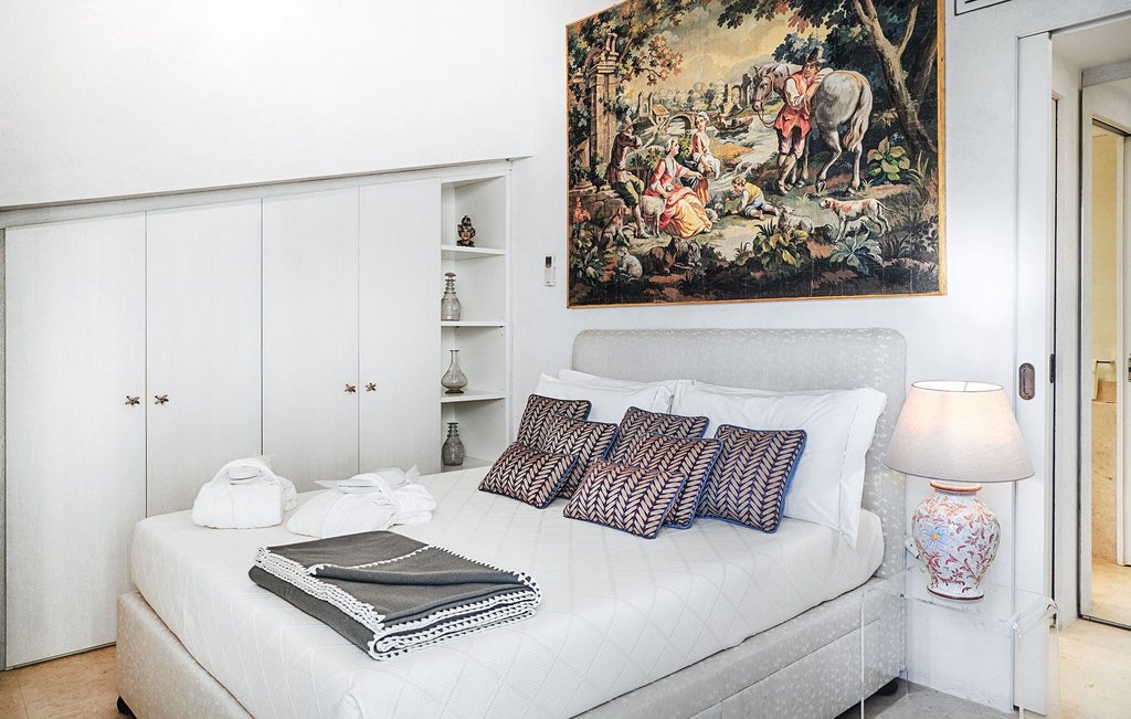 Elegant Sicilian hotel room with soft pastel linens, antique wooden furniture, and large arched windows overlooking lush Mediterranean garden landscape