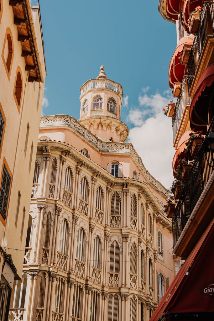 Elegant guided tour through cobblestone streets of Palma, showcasing historic architecture, ornate balconies, and Mediterranean sunlight in Mallorca, Spain