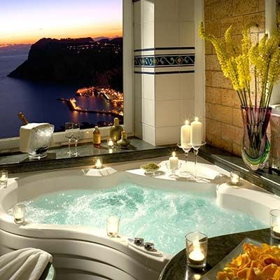 Elegant 5-star cliffside hotel in Capri with infinity pool overlooking the Mediterranean Sea, surrounded by manicured gardens