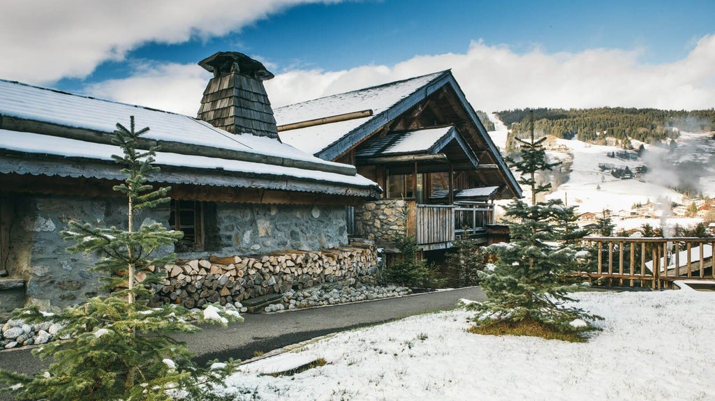 Luxurious alpine chalet nestled in snow-covered French mountains, featuring elegant wood-paneled exterior and warm, inviting winter landscape.