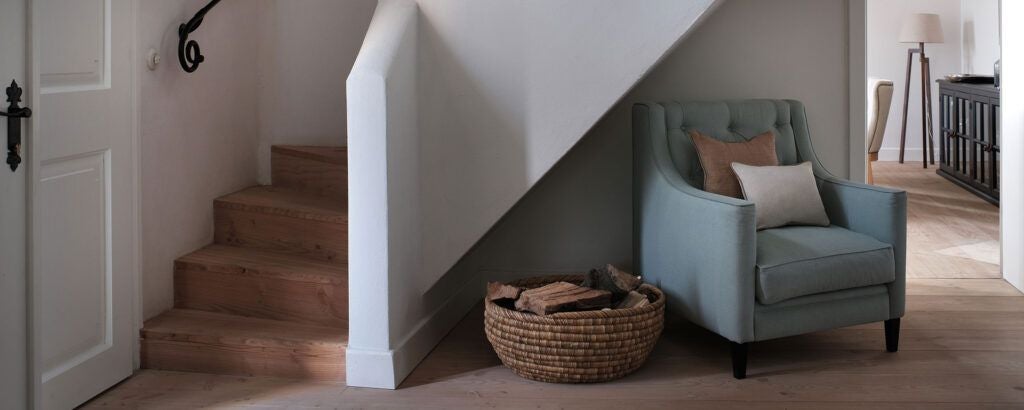 Rustic wooden interior of renovated caretaker's house at Bethlen Estates, featuring warm earth tones, elegant traditional Transylvanian craftsmanship, and soft natural lighting