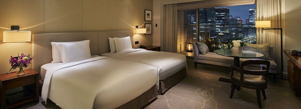 Luxurious hotel room at Palace Hotel Tokyo with floor-to-ceiling windows, elegant king bed, and stunning Wadakura Fountain Park view from private balcony