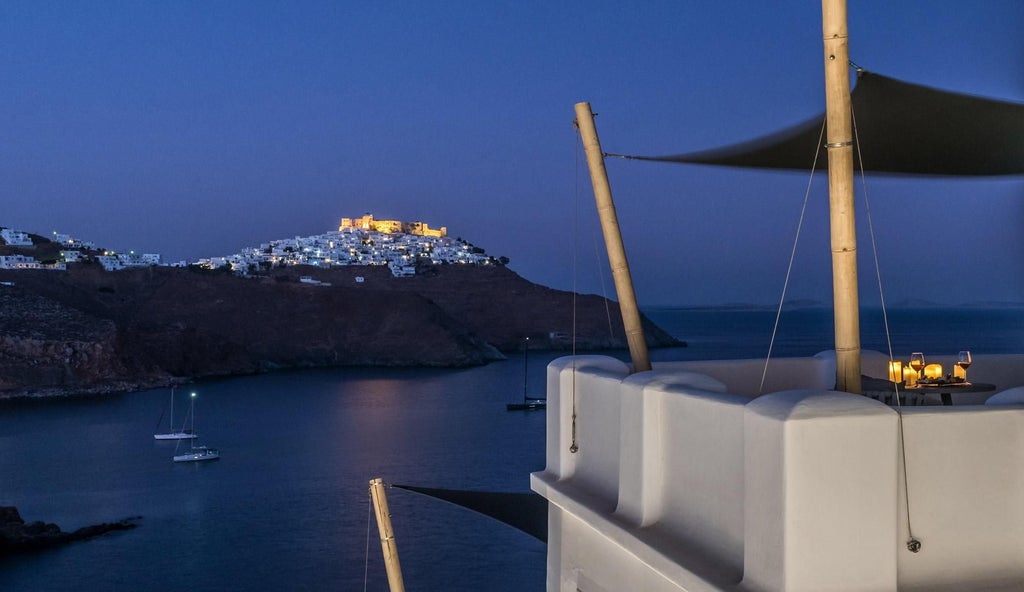 Elegant white-washed Greek suite with azure Aegean Sea view, featuring minimalist design, private balcony, and traditional Cycladic architectural elements