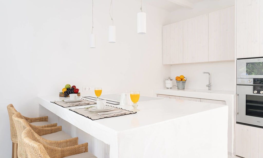 Elegant Portuguese-style superior hotel room with whitewashed walls, minimalist design, soft natural light, and rustic wooden furniture at Scenset Vila Monte.