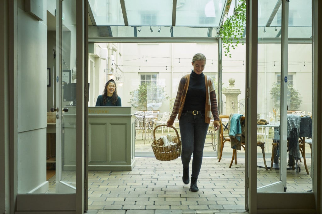 Historic stone-facade luxury boutique hotel with elegant windows, nestled in picturesque United Kingdom countryside, showcasing timeless architectural charm and refined hospitality.