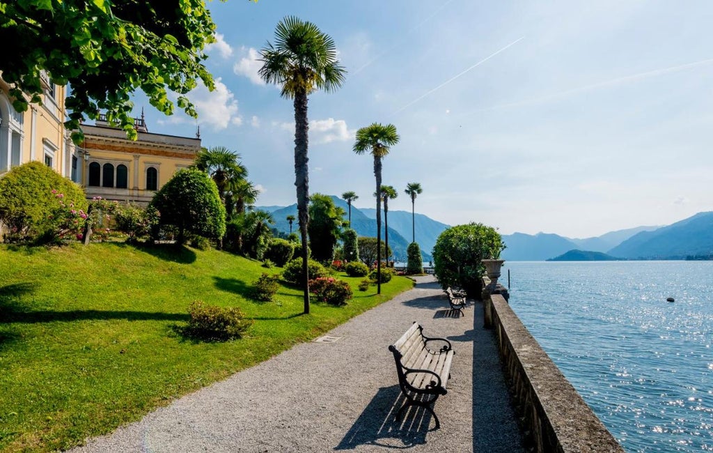 Historic luxury hotel with ornate Renaissance facade, lakeside terrace, and manicured gardens overlooking Lake Como in Northern Italy