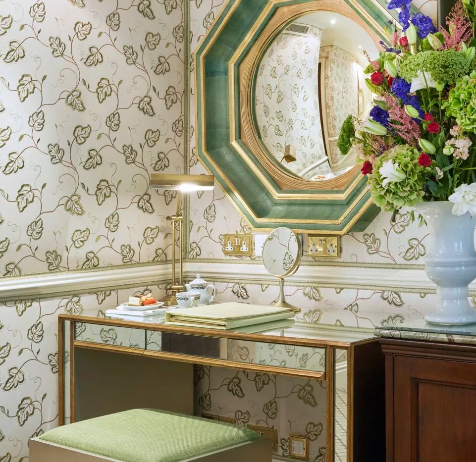 Elegant Superior Queen room at The Milestone Hotel & Residences, featuring plush bedding, soft neutral tones, and refined traditional British decor with delicate accents.